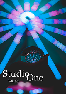Studio One Volume 42 issue cover; hands holding a glass sphere reflecting the image of a ferris wheel lit up at night